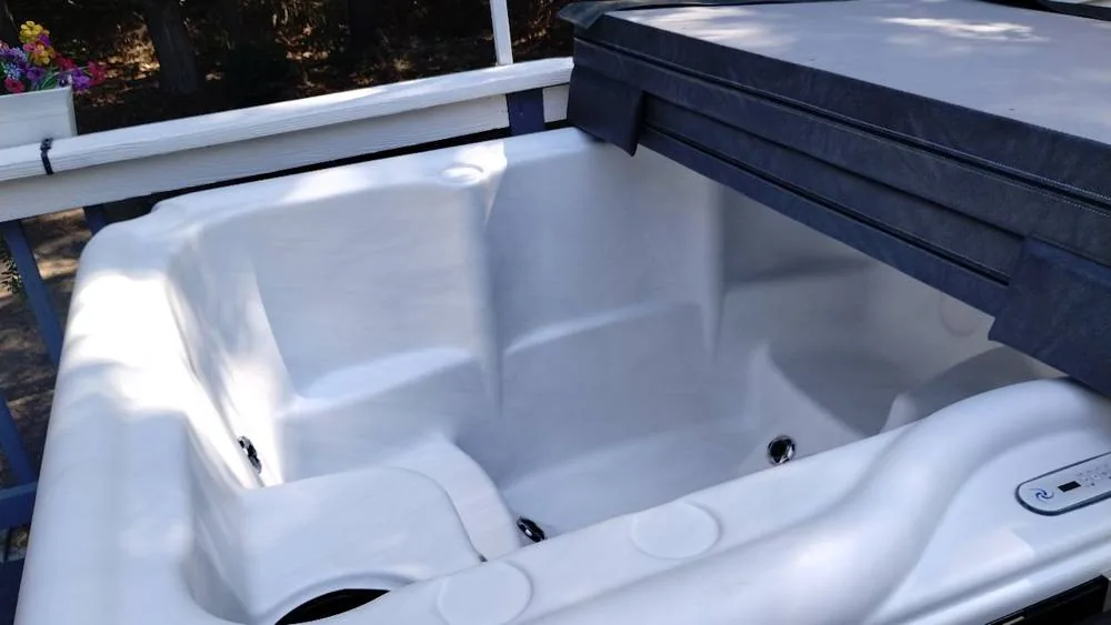 White Nordic hot tub seating and folded cover following Pool Store delivery