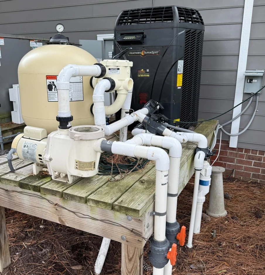Pool pump, filter, heater and exposed plumbing photographed during a Pool Store inspection