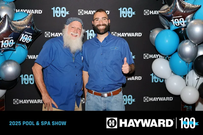 Father and son in Pool Store shirts at the 2025 Pool & Spa Show