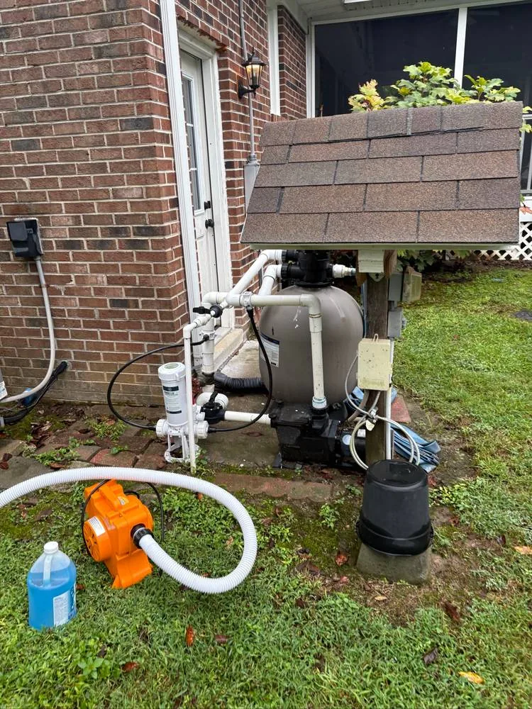 Pool equipment, blower and hose photographed during a winterization visit